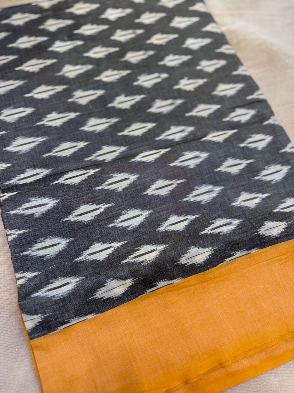 traditional-handloom-ikkat-saree-featuring-charcoal-grey-pallu-and-mustard-yellow