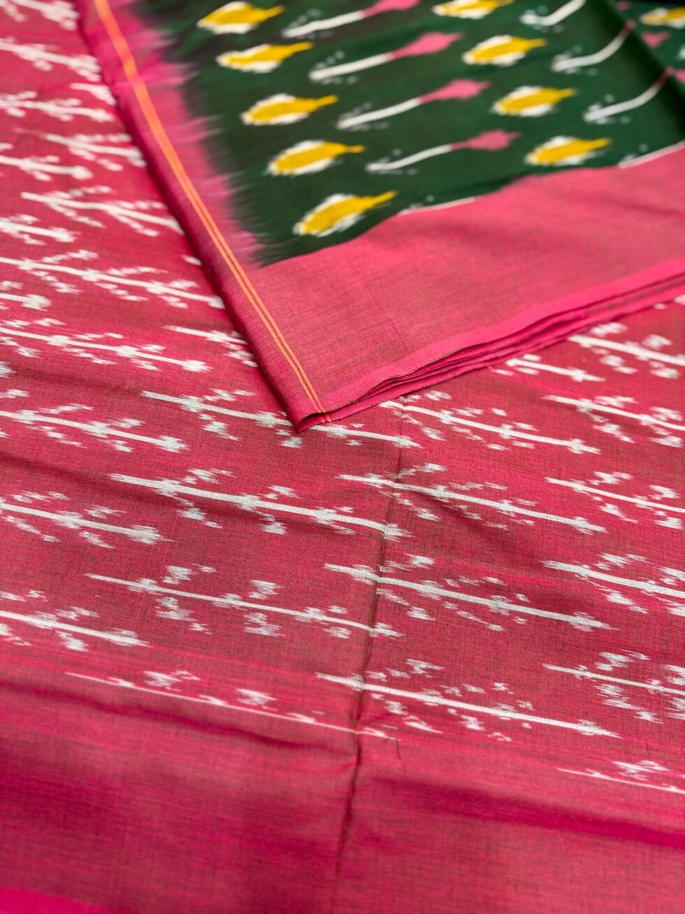 traditional-handloom-ikkat-saree-featuring-rani-pink-border-and-bottle-green-body